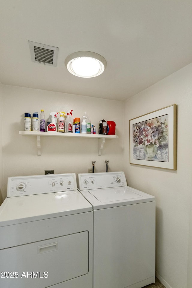 clothes washing area with washer and clothes dryer