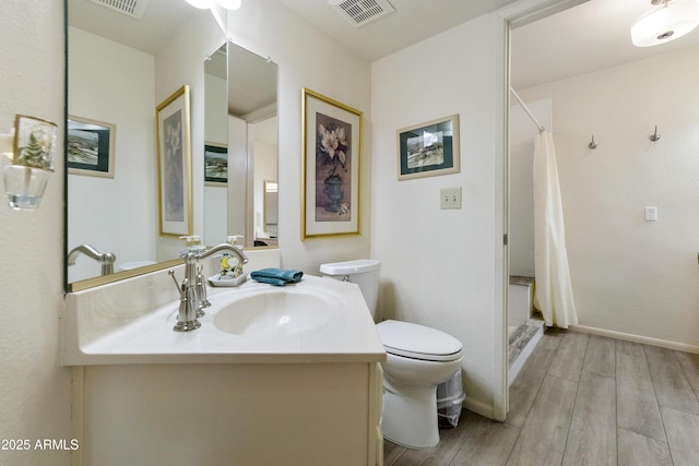 bathroom with vanity, hardwood / wood-style flooring, a shower with curtain, and toilet