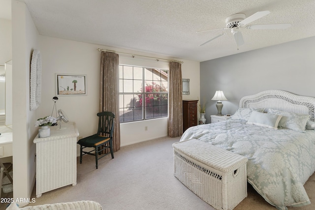 carpeted bedroom featuring ceiling fan and a textured ceiling