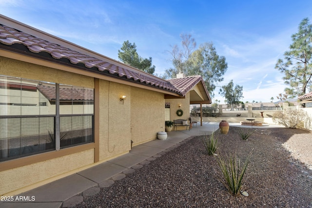 view of property exterior with a patio