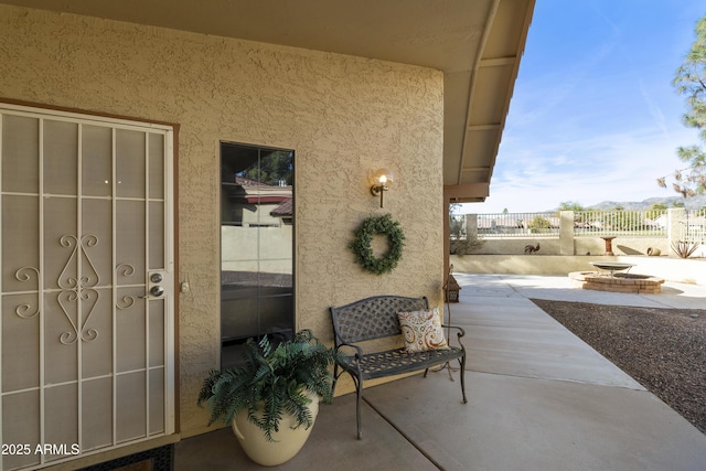 view of exterior entry featuring a patio