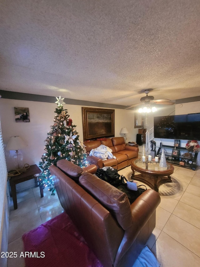 tiled living room with ceiling fan and a textured ceiling