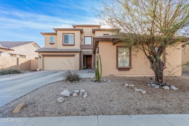 view of front of home with an attached garage, fence, driveway, a tiled roof, and stucco siding