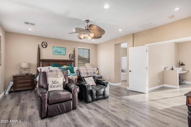 bedroom featuring ceiling fan, hardwood / wood-style floors, and ensuite bathroom