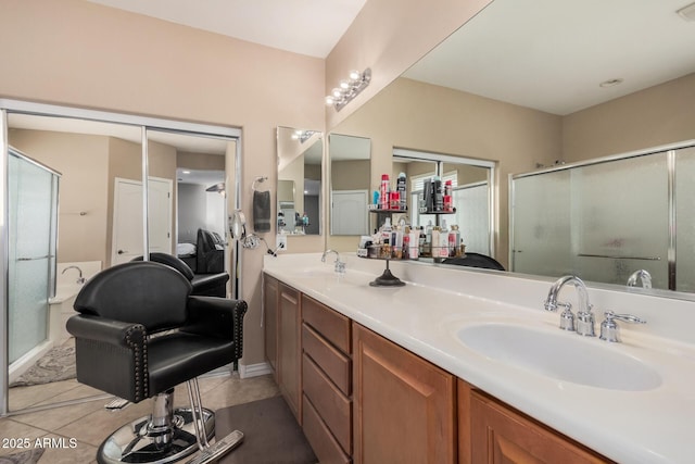 bathroom featuring vanity, walk in shower, and tile patterned floors