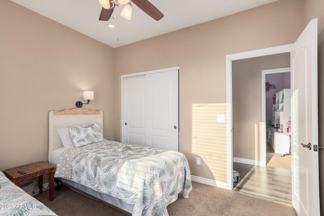 carpeted bedroom with ceiling fan and a closet