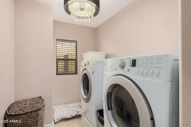 clothes washing area with mail boxes, a chandelier, washing machine and dryer, and light tile patterned floors