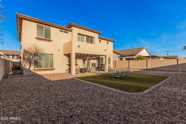 back of property with a patio