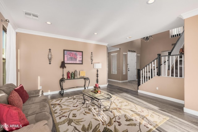 living room featuring hardwood / wood-style floors and crown molding