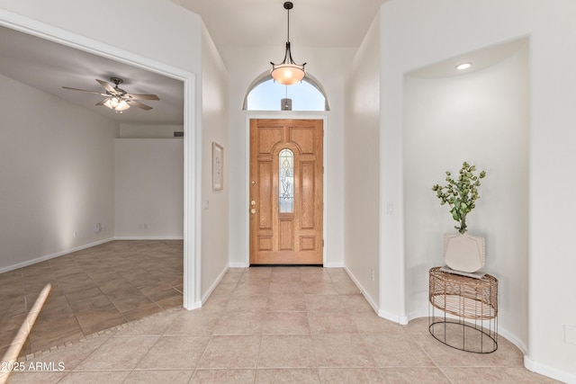 foyer entrance featuring ceiling fan and light tile patterned floors