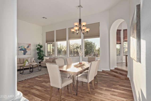 dining space featuring a notable chandelier and hardwood / wood-style floors