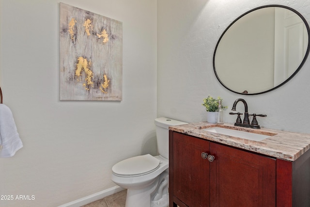 bathroom with toilet, tile patterned floors, and vanity