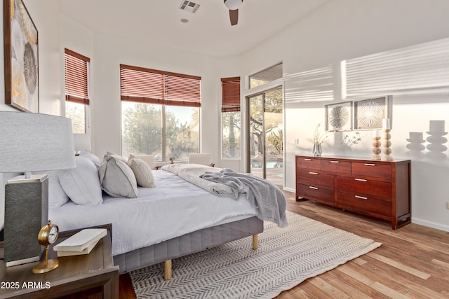 bedroom featuring access to outside, ceiling fan, and light hardwood / wood-style floors