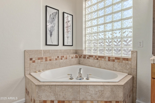 bathroom with a relaxing tiled tub