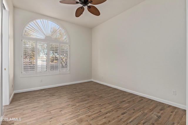 unfurnished room with ceiling fan and wood-type flooring