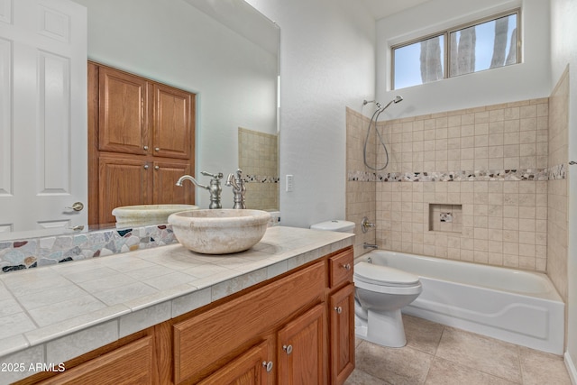 full bathroom featuring vanity, tile patterned flooring, tiled shower / bath combo, and toilet