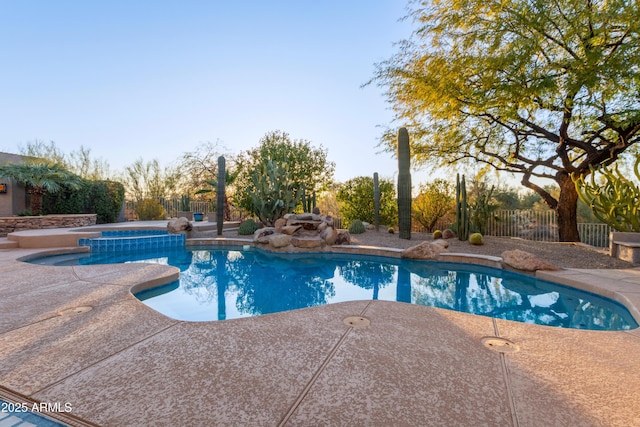 view of swimming pool with an in ground hot tub and a patio