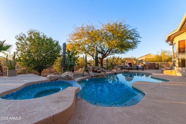 view of swimming pool with a patio, exterior fireplace, and an in ground hot tub