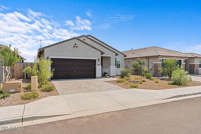 single story home with fence, driveway, an attached garage, and stucco siding