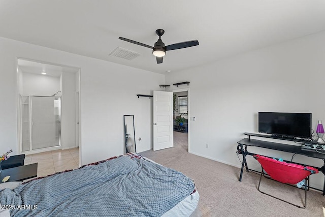 bedroom featuring ceiling fan, a barn door, light colored carpet, visible vents, and baseboards