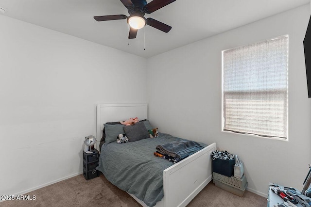 bedroom with ceiling fan, baseboards, and light colored carpet