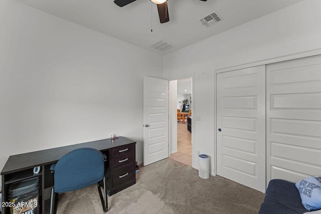 home office with a ceiling fan, light colored carpet, and visible vents