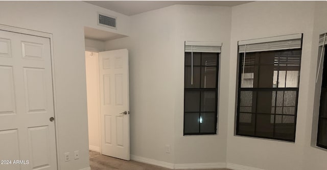 unfurnished bedroom with light colored carpet