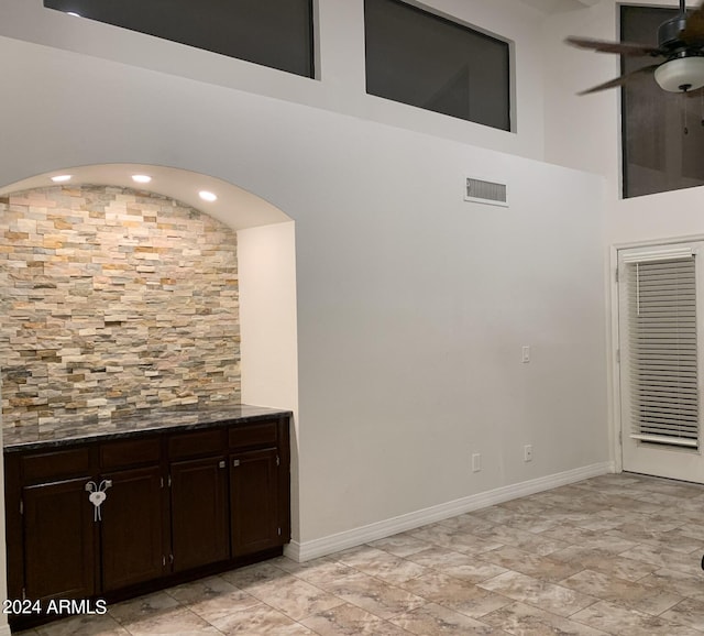 interior space with ceiling fan