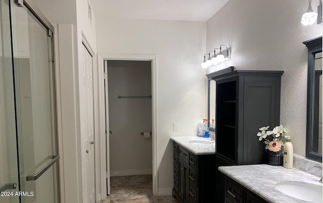 bathroom featuring walk in shower and vanity