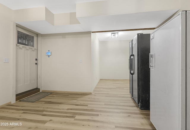 foyer with light wood-style floors