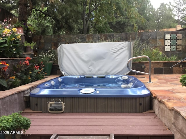 wooden deck featuring a hot tub