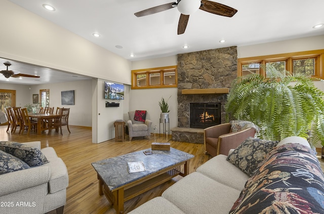 living area featuring ceiling fan, recessed lighting, a fireplace, and wood finished floors