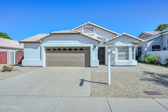 5226 W Pontiac Dr, Glendale, AZ 85308 - ranch-style home featuring a tiled roof, a garage, concrete driveway, fence, and stucco siding