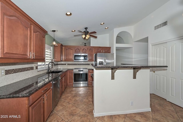 5226 W Pontiac Dr, Glendale, AZ 85308 - kitchen with appliances with stainless steel finishes, a kitchen breakfast bar, visible vents, ceiling fan, and a sink