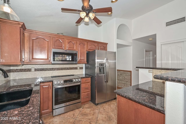 5226 W Pontiac Dr, Glendale, AZ 85308 - kitchen featuring stainless steel appliances, visible vents, a sink, and decorative backsplash