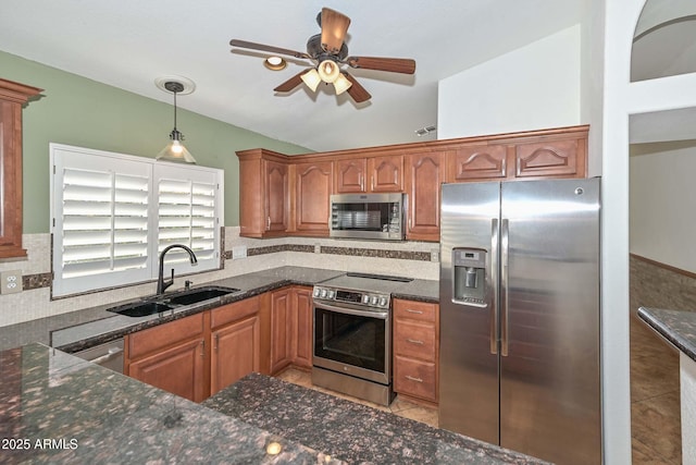 5226 W Pontiac Dr, Glendale, AZ 85308 - kitchen featuring appliances with stainless steel finishes, vaulted ceiling, dark stone countertops, ceiling fan, and a sink