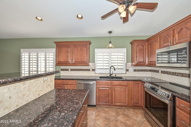 5226 W Pontiac Dr, Glendale, AZ 85308 - kitchen featuring dark stone counters, decorative backsplash, stainless steel appliances, a sink, and ceiling fan