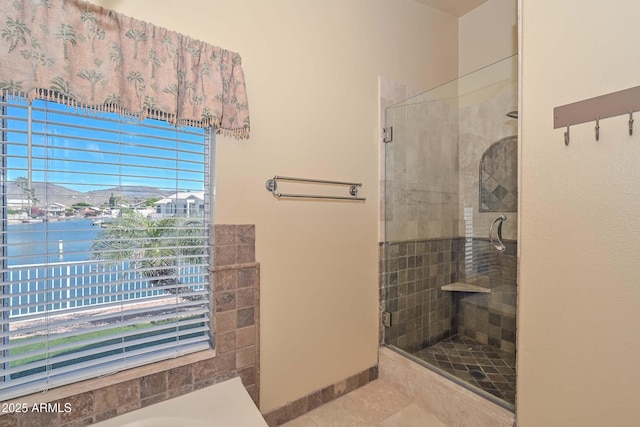 5226 W Pontiac Dr, Glendale, AZ 85308 - bathroom with baseboards, tile patterned flooring, a shower stall, a water view, and a garden tub