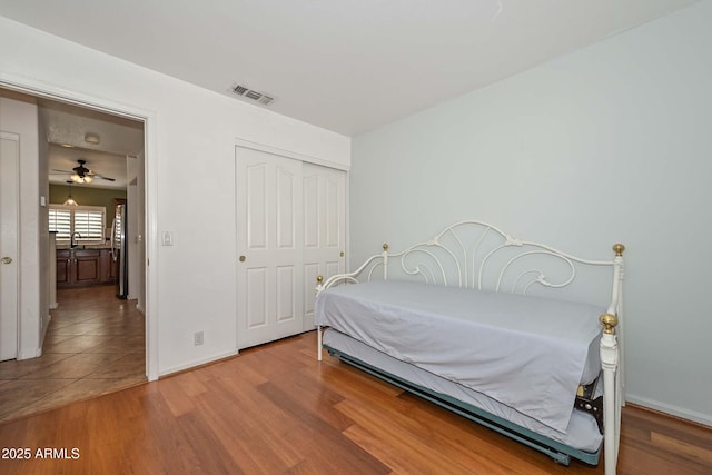 5226 W Pontiac Dr, Glendale, AZ 85308 - bedroom featuring a closet, visible vents, wood finished floors, a sink, and baseboards