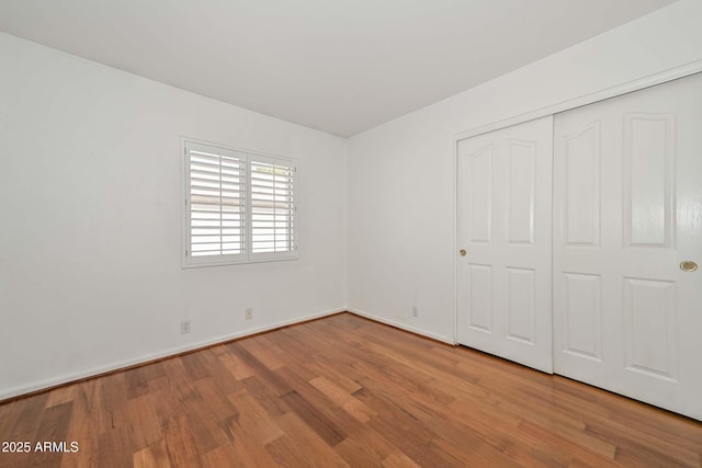 5226 W Pontiac Dr, Glendale, AZ 85308 - unfurnished bedroom with a closet, baseboards, and wood finished floors