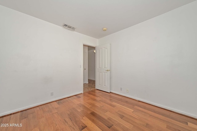 5226 W Pontiac Dr, Glendale, AZ 85308 - unfurnished room featuring wood finished floors, baseboards, and visible vents