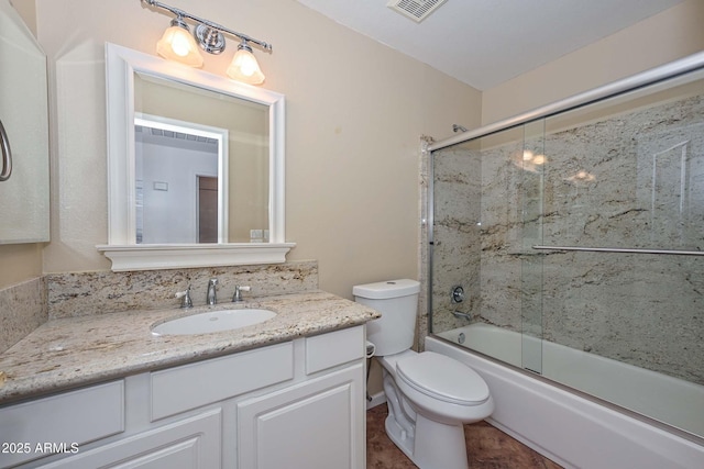 5226 W Pontiac Dr, Glendale, AZ 85308 - full bathroom featuring toilet, vanity, visible vents, and bath / shower combo with glass door