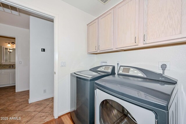5226 W Pontiac Dr, Glendale, AZ 85308 - clothes washing area with washing machine and clothes dryer, a sink, cabinet space, and light tile patterned floors