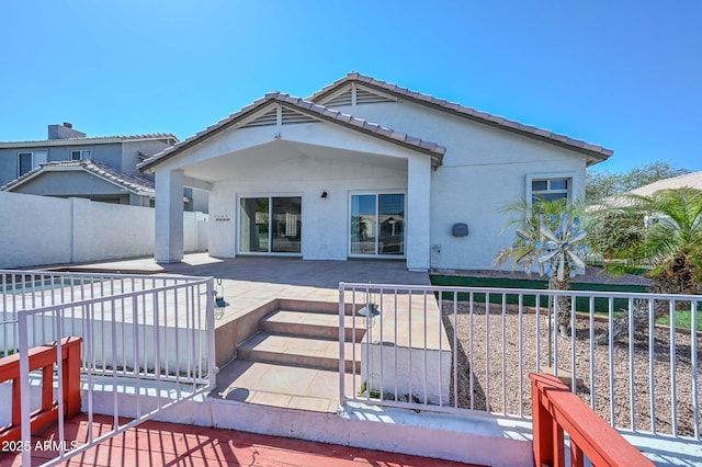 5226 W Pontiac Dr, Glendale, AZ 85308 - back of property with a patio area, a tiled roof, fence, and stucco siding