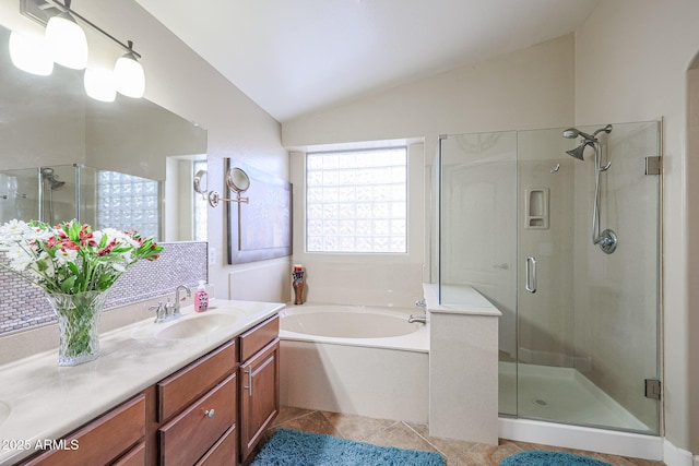 bathroom featuring tile patterned flooring, vanity, separate shower and tub, and vaulted ceiling