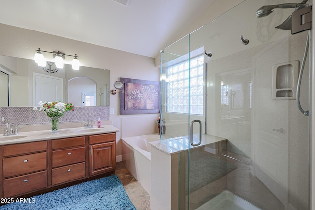 bathroom featuring decorative backsplash, shower with separate bathtub, vanity, and tile patterned floors