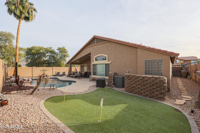 view of pool with a patio and central AC unit