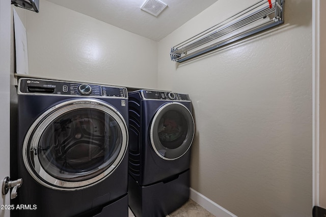 laundry room featuring washing machine and clothes dryer