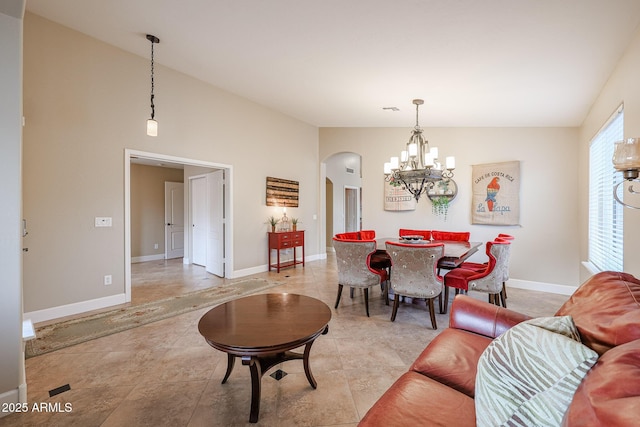 dining room with vaulted ceiling and an inviting chandelier