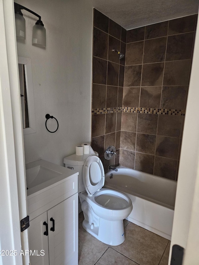 bathroom with toilet, washtub / shower combination, vanity, and tile patterned floors